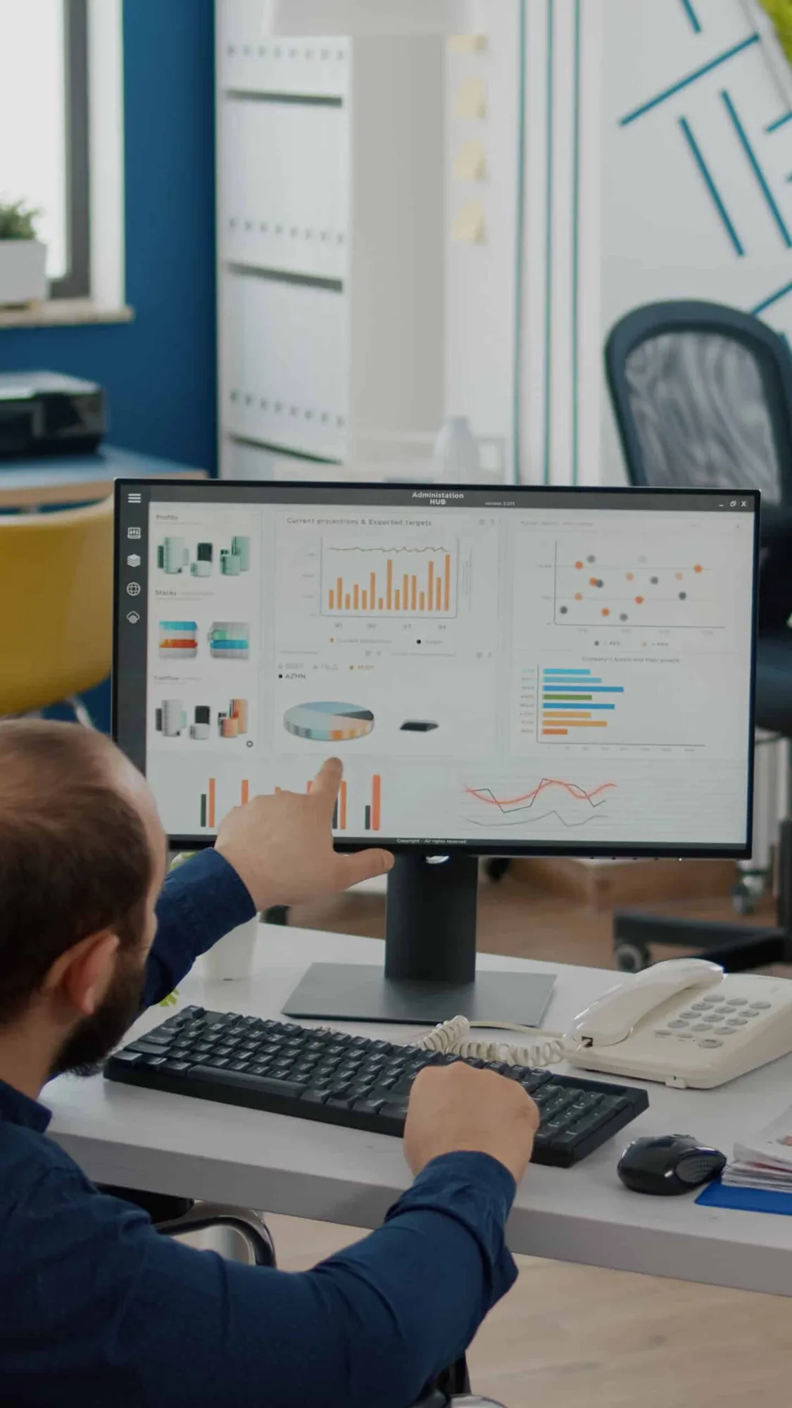 A benefits analyst reviewing pharmacy plan charts on a dashboard
